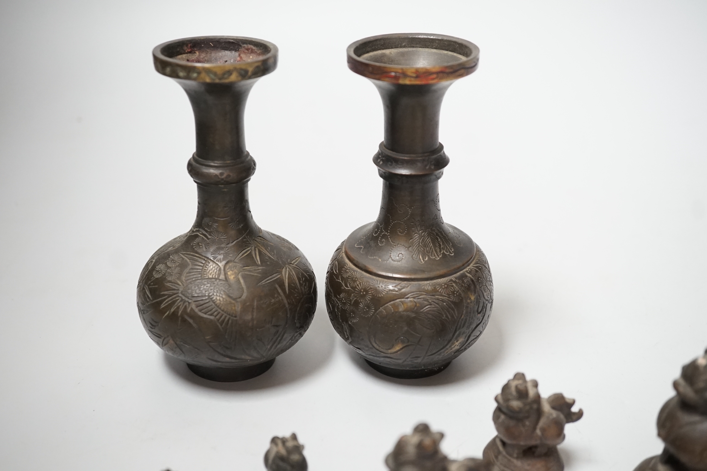 A set of Burmese bronze weights and a pair of bronze vases, 12cm